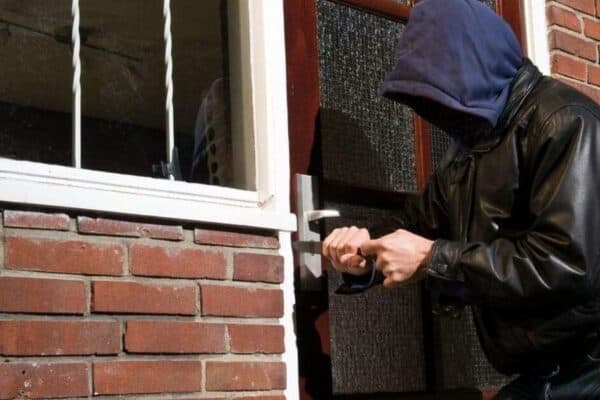 security products - a man attempting to break into a house to commit burglary